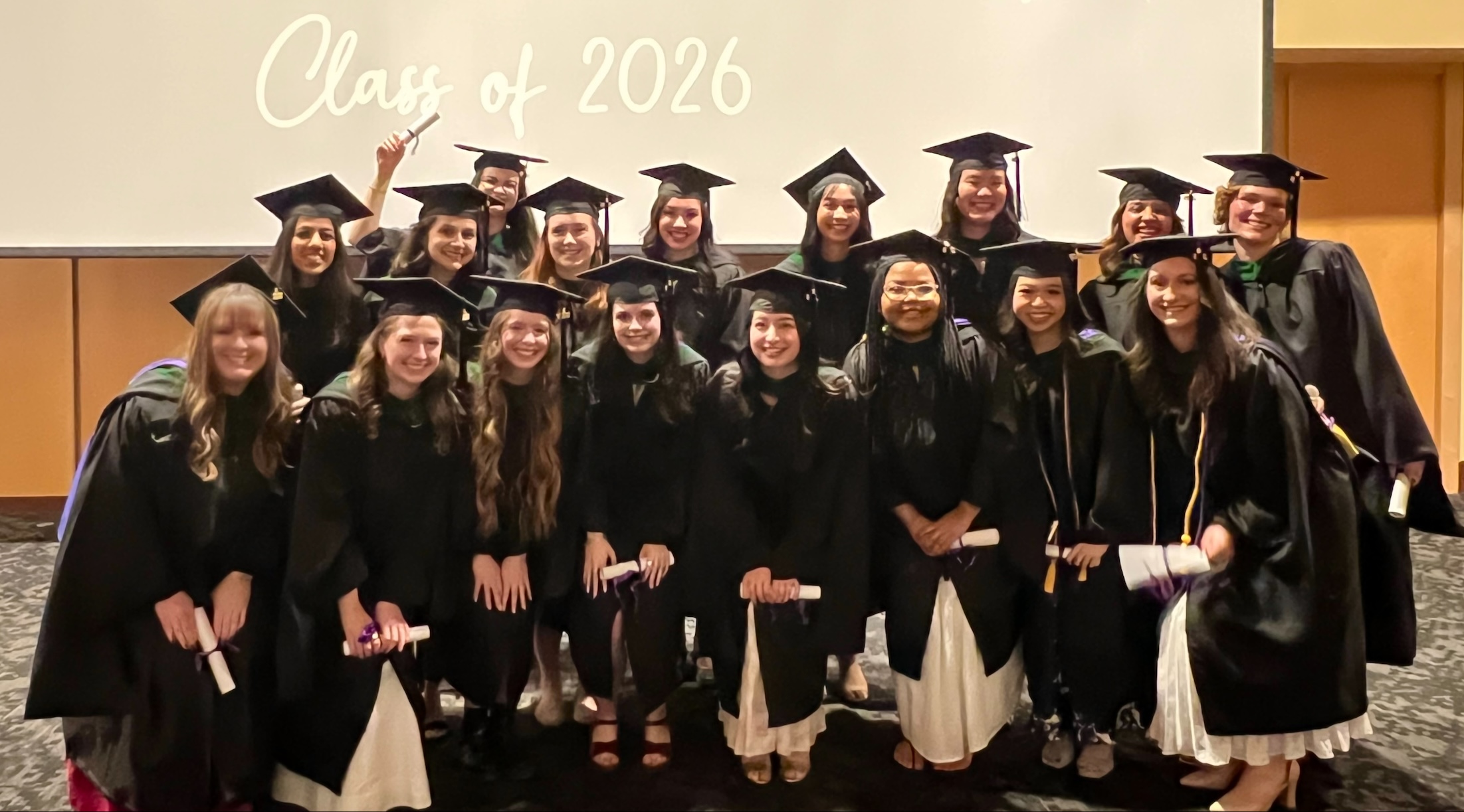 Class of 2026 stands in the auditorium after the ceremony.