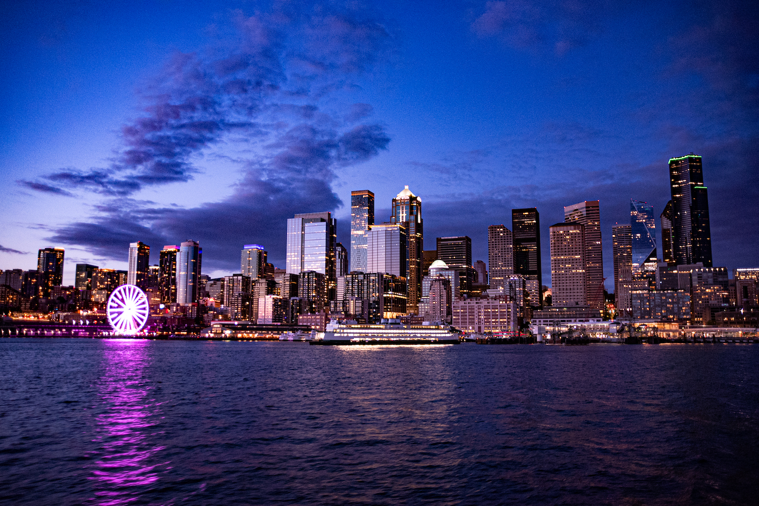 Downtown Seattle cityscape at night by the Puget Sound